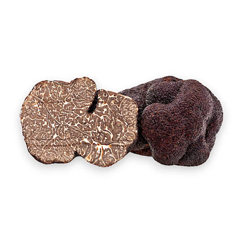 Ganze und aufgeschnittene Tuber melanosporum Black Truffles mit dem dunkel marmorierten Inneren