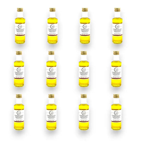 Yellow olive oil bottles with white labels and gold caps for White Truffle Extra Virgin Olive Oil